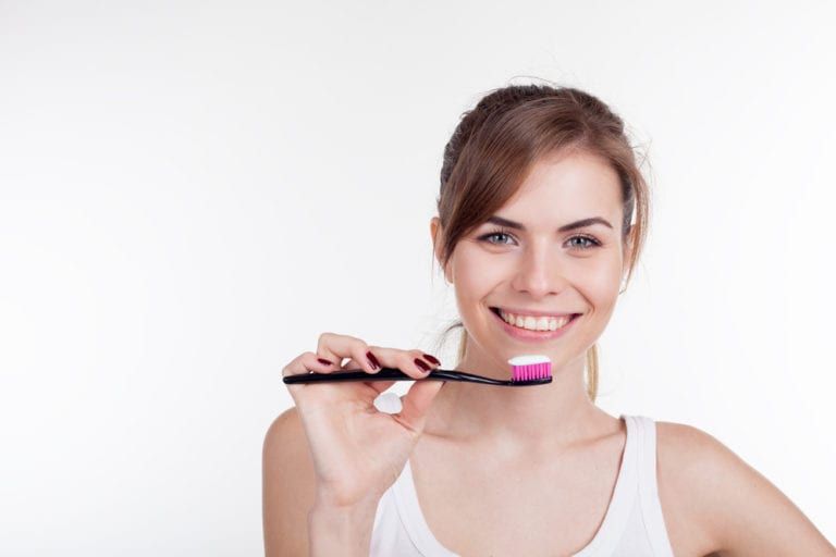 girl is going to brush teeth with a toothbrush